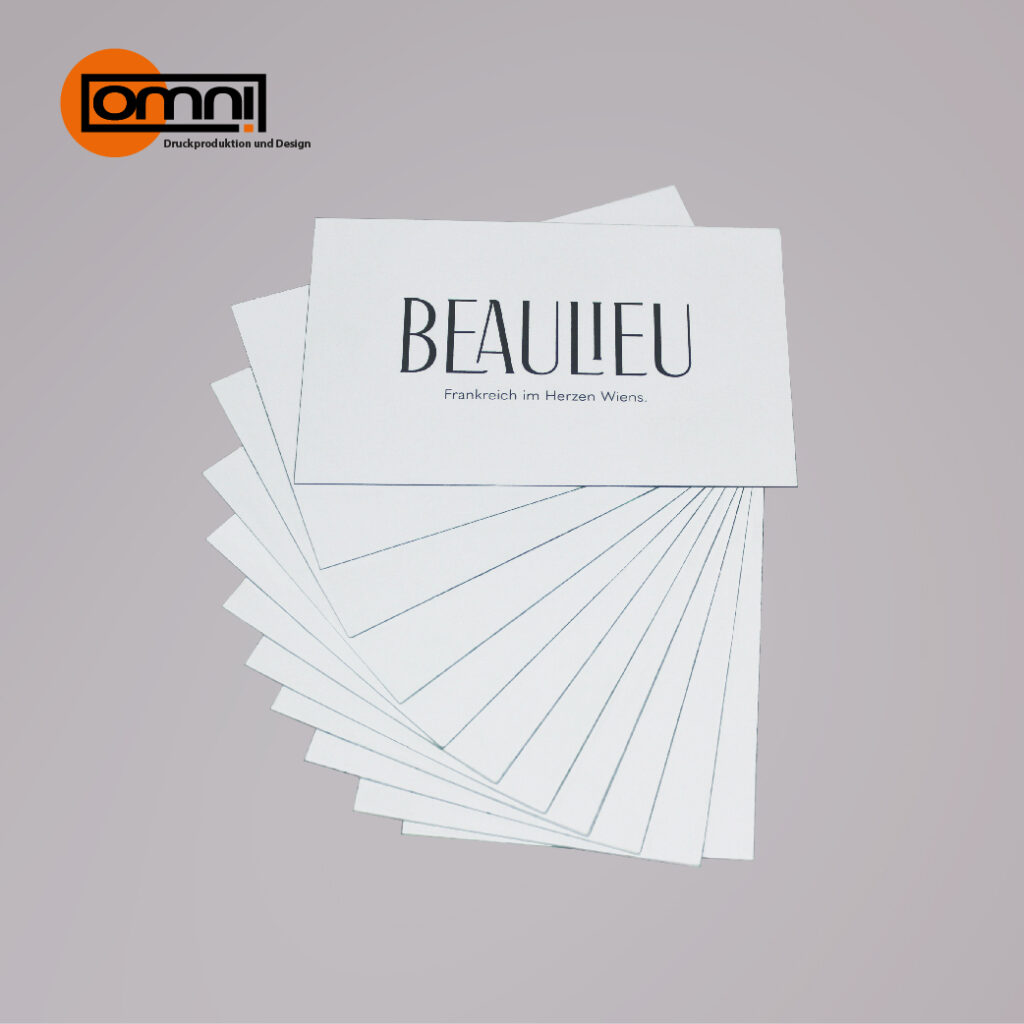 Weiße Visitenkarten wo Firma Beaulieu draufsteht Omnidruck Logo wird oben angezeigt.